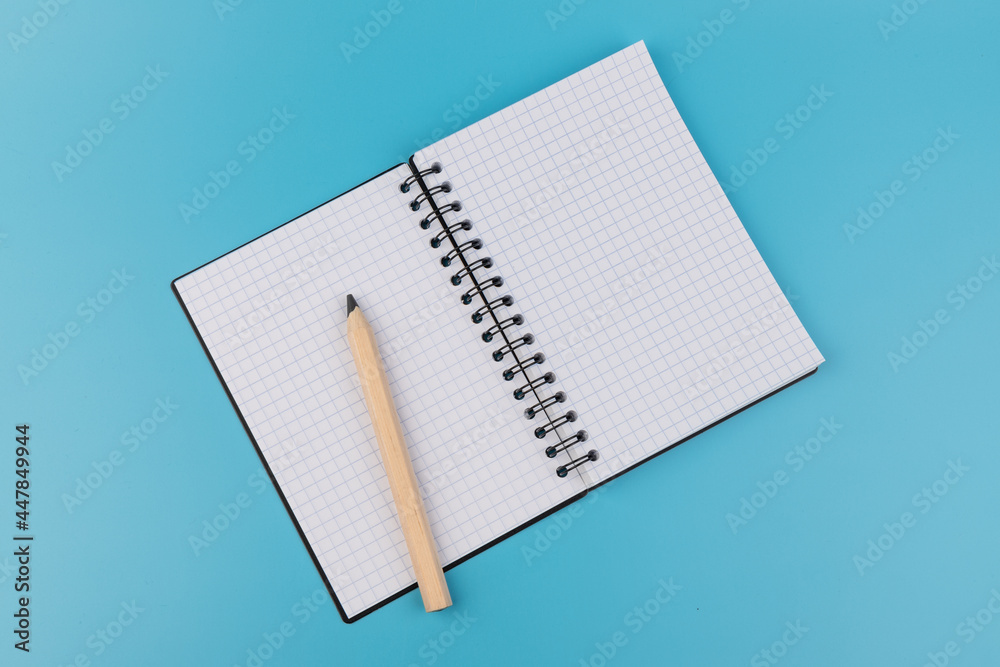 Blank paper and pencil on a blue background Blank paper and pencil on a blue background