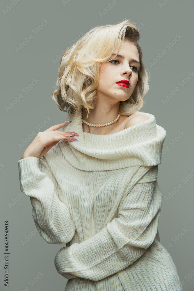 Half-length portrait of young woman in retro style, fashion of 70s, 80s years isolated on gray studio background with copyspace for ad. Half-length portrait of young woman in retro style, fashion of 70s, 80s years isolated on gray studio background with copyspace for ad.
