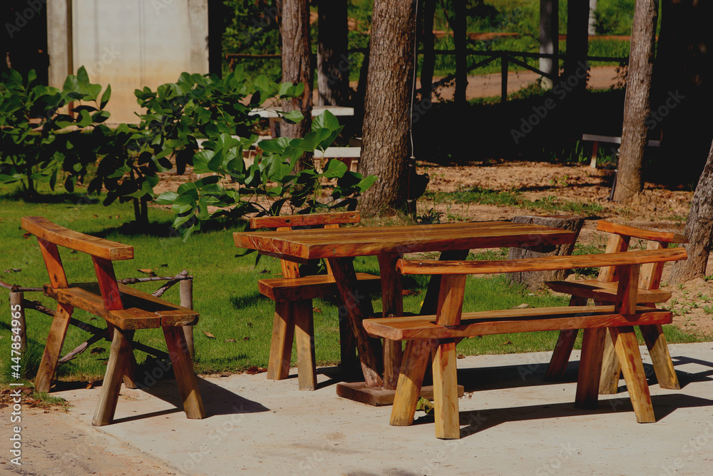 Tables and chairs made of wood in the garden.