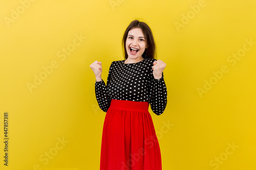 Young beautiful pregnant woman on isolated colored background celebrating surprised and amazed for success with arms raised and open eyes. Winner concept