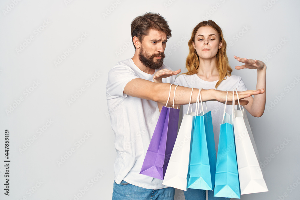 young couple in white t-shirts packages lifestyle shopping sale young couple in white t-shirts packages lifestyle shopping sale