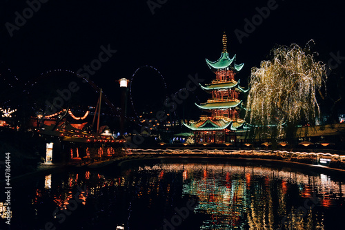 Vertical shot of a fir tree with shiny Christmas decorations in Tivoli Gardens