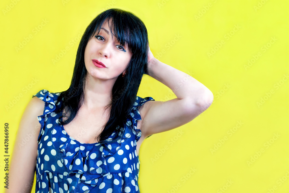 A young beautiful black haired woman on yellow background, isolated. A young beautiful black haired woman on yellow background, isolated.