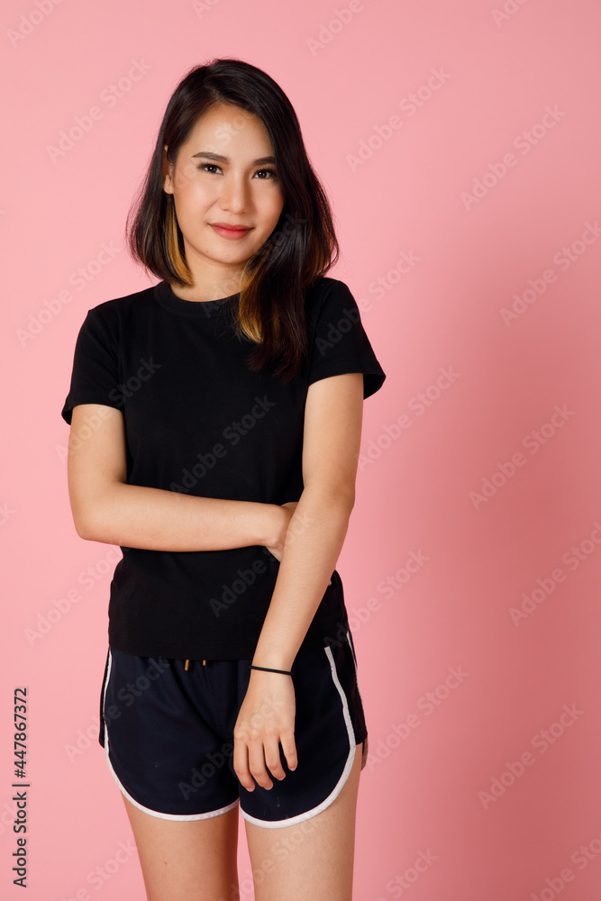 Obraz premium Active and sporty character young and cute Asian girl in t-shirt and shorts posing to the camera with self-confidence.
