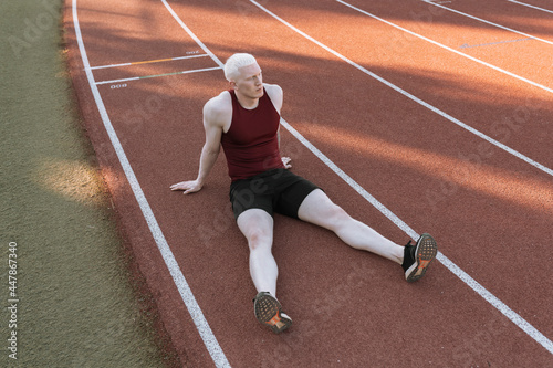 athlete man sitting on running track