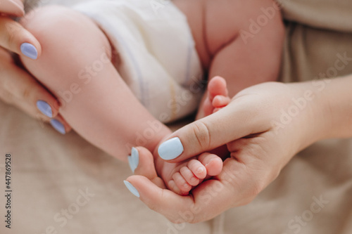 Mother holding baby feet