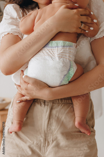 Mother holding baby in diaper