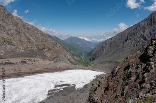 View of Mayly glacier and Genaldon river valley on sunny summer day. North Ossetia–Alania, Caucasus, Russia.