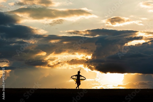 The shadow of the traditional dancers of southern Thailand with beautiful poses. With the sunlight in the evening, it's beautiful.