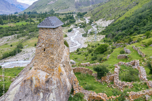 Medieval tower on the rock. View of Amirkhan tower (17-18th centuries ) in  Verhnyaya Balkaria village. Kabardino-Balkaria, Caucasus, Russia. photo