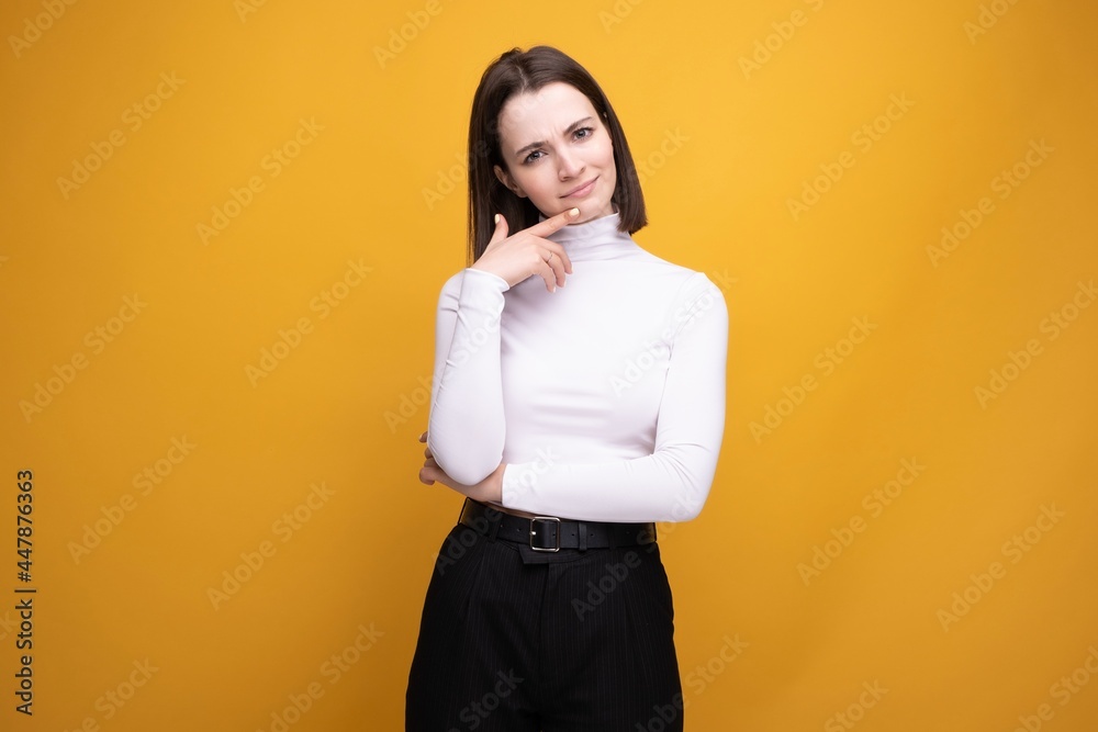 Close-up portrait of a surprised brunette on a yellow background Close-up portrait of a surprised brunette on a yellow background