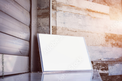 Empty white timetable sheet with mockup place stands on counter