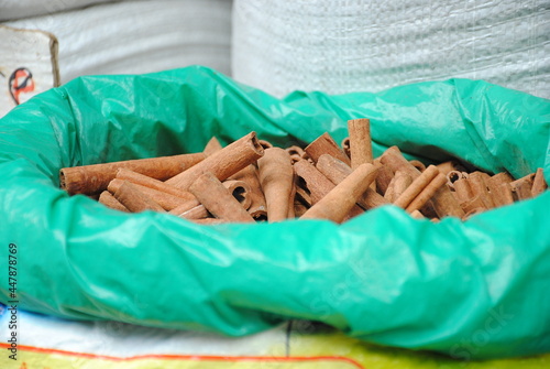 Dried bark strips of Cinnamon in a plastic sack at the spice market. This  spice obtained from the inner bark of several tree species from the genus Cinnamonum photo