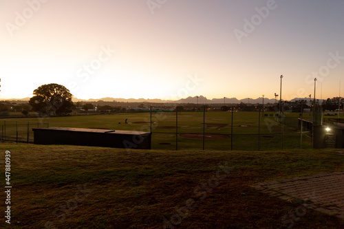 Landscape of baseball field and surrounding countryside at sunrise