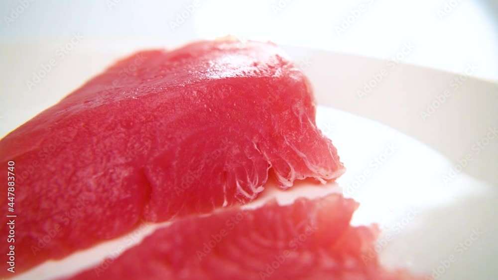Tuna fillet on a white plate close-up. Cooking sushi rolls
Tuna fillet on a white plate close-up. Cooking sushi rolls