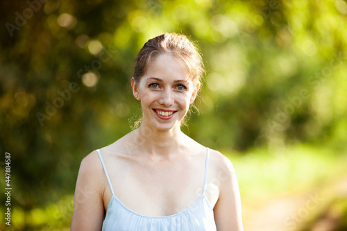 Portrait of a beautiful young woman in a blue dress