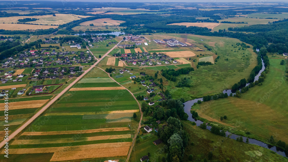 Aerial landscape of winding river in green field, top view of beautiful nature background from drone, seasonal summer landscape with copy space.