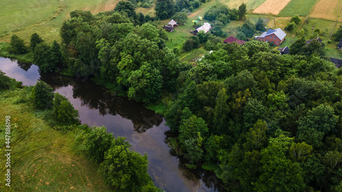 Aerial landscape of winding river in green field, top view of beautiful nature background from drone, seasonal summer landscape with copy space. © kalyanby