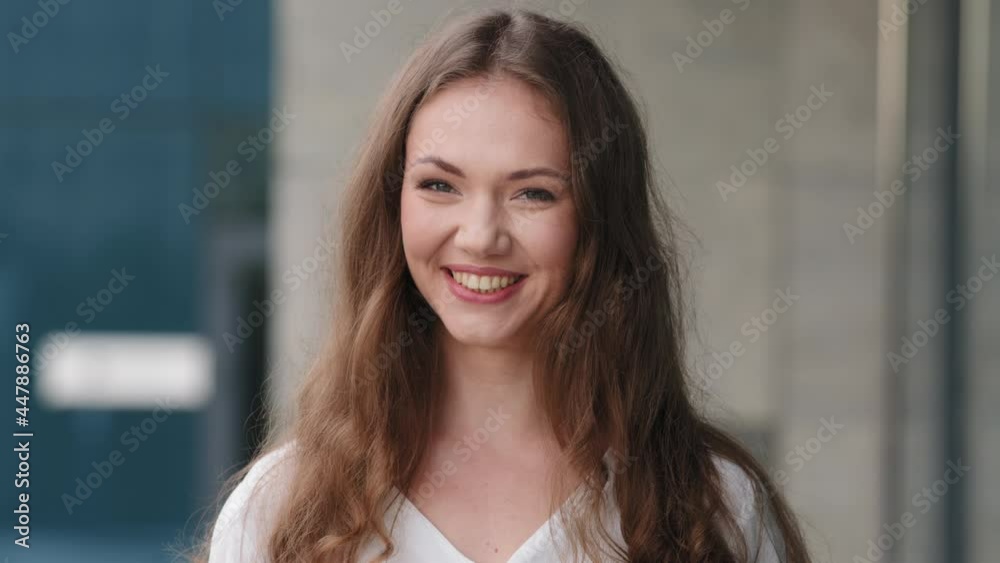 Outdoors portrait young girl model millennial caucasian woman student girlfriend lady female wife client looking at camera laughing sincerely toothy smiling smiles cheerfully laughs joke having fun