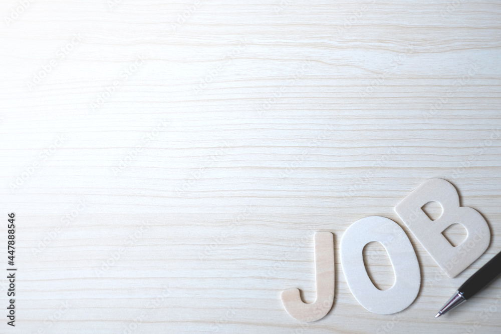 The word JOB, Wooden letters on a wooden table. The word JOB, Wooden letters on a wooden table.