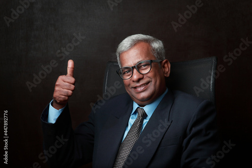 Happy Indian business man shows thumbs up