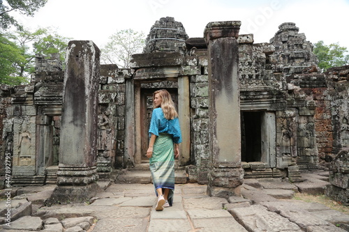 Happy woman traveller walking in Angkor Wat Cambodia.
