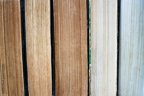 Pages of old shabby books close up. Side view.