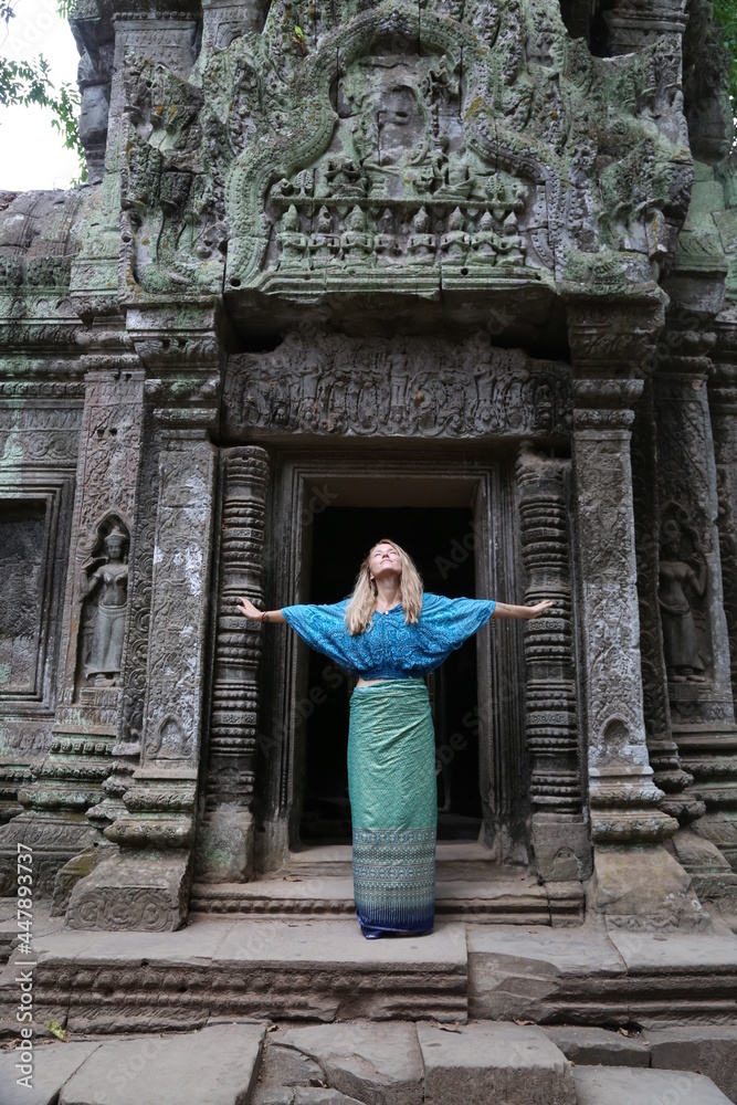 Happy woman traveller walking in Angkor Wat Cambodia.