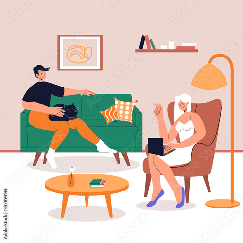 Young happy couple spend time together at home. A man sits on a sofa with a cat on her knees. Male Character Sitting on chair with Laptop. Home Office. Lifestyle after quarantine.