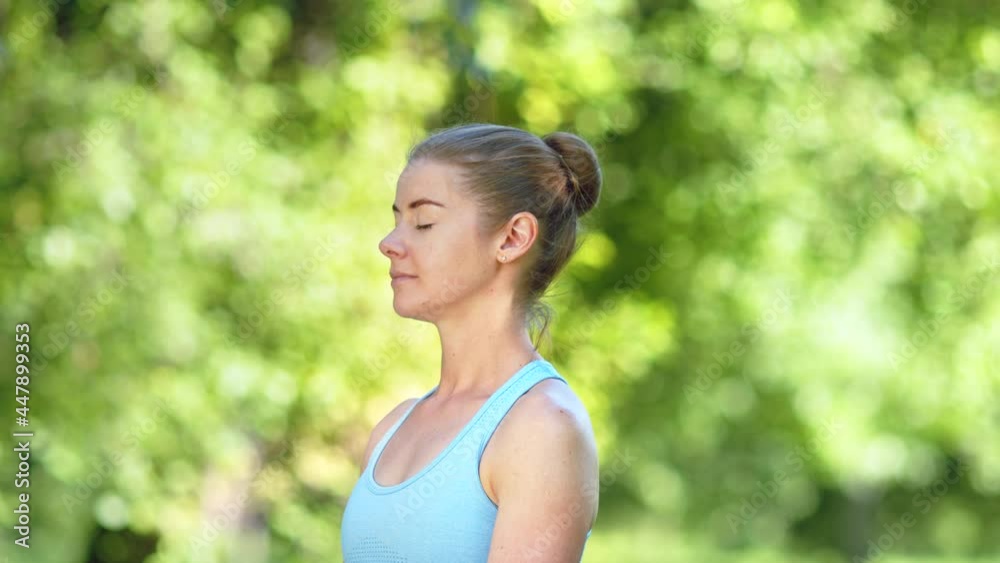 Lady with hair bun relaxes after exercises and meditates Lady with hair bun relaxes after exercises and meditates