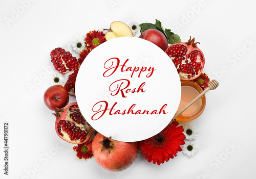 Flat lay composition with Rosh Hashanah holiday attributes and card on white background