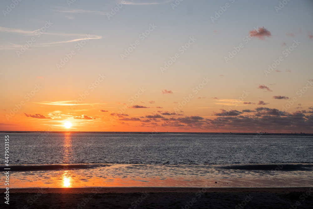Sunset sky over sea in the evening with colorful clouds orange sunlight . High quality photo
