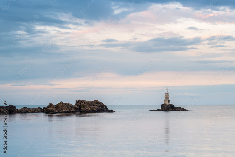 Amazing sunset view with an old lighthouse at the Black Sea coast