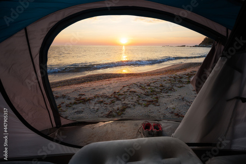 Sea sunrise view from inside of a tent