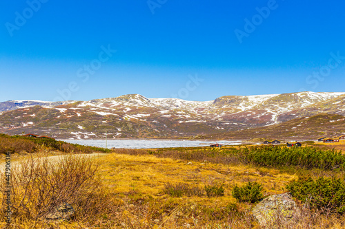 Frozen turquoise lake Vavatn panorama in summer landscape Hemsedal Norway. photo