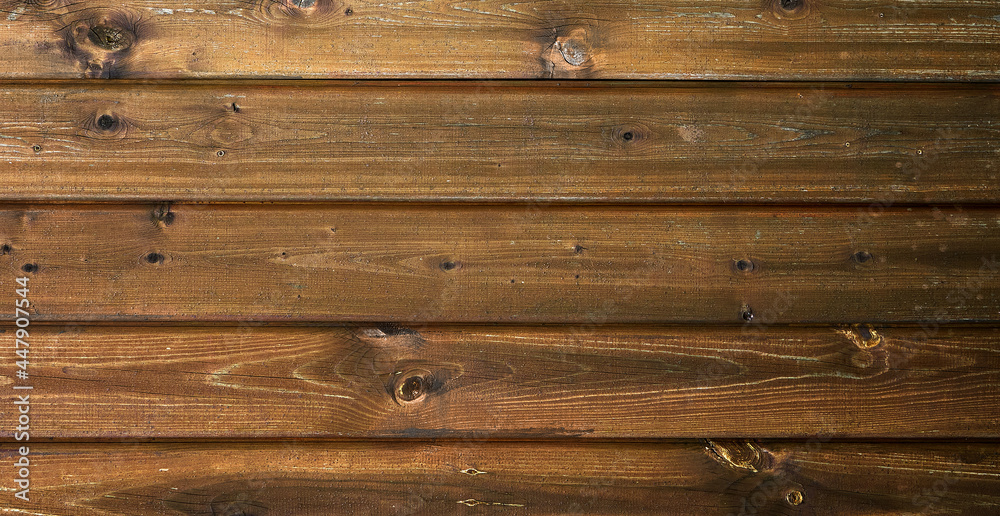 Naklejka premium Flat lay dark textured wooden background made of brown boards. Old rustic horizontal boards. The concept is ecology, vintage, village, nature. Space for text. 
