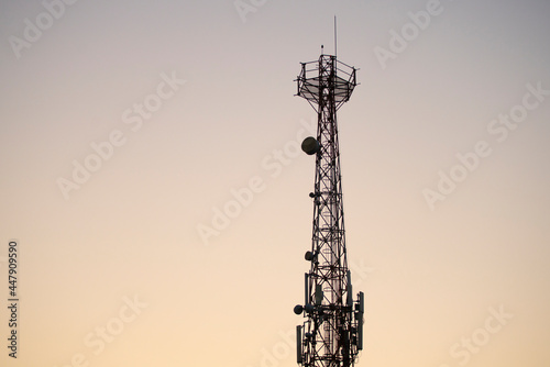 Communications tower with sunset sky background 