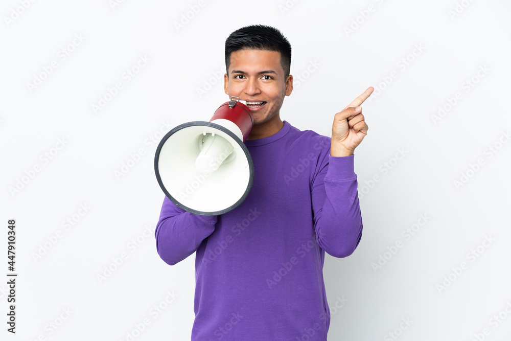 Young Ecuadorian man isolated on white background shouting through a megaphone and pointing side Young Ecuadorian man isolated on white background shouting through a megaphone and pointing side