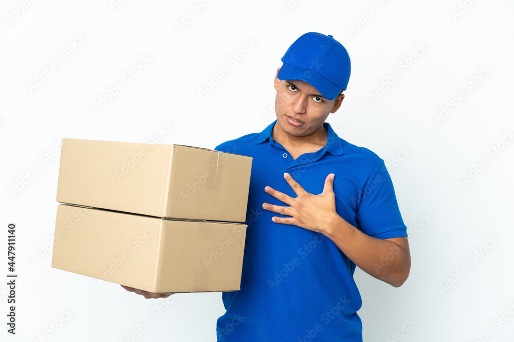 Delivery Ecuadorian man isolated on white background surprised and shocked while looking right Delivery Ecuadorian man isolated on white background surprised and shocked while looking right