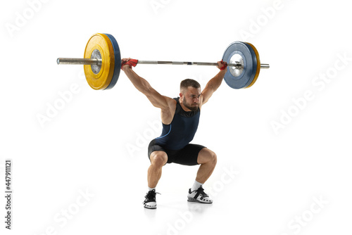 Принти на полотні Full length portrait of a man in sportswear exercising with a weight isolated on