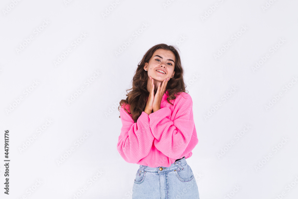Young beautiful woman with freckles light makeup in sweater on white background cheerful happy positive smile Young beautiful woman with freckles light makeup in sweater on white background cheerful happy positive smile