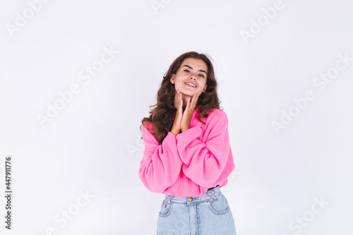 Young beautiful woman with freckles light makeup in sweater on white background cheerful happy positive smile