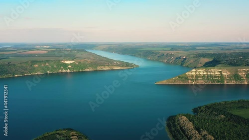 Wonderful Aerial View of the Forest Landscape and Wide River. Blue River surrounded by Rocky Hills. Beautiful View on wild Nature without People. Ukrainian Bakota. Bay. Drone. Ecology. photo