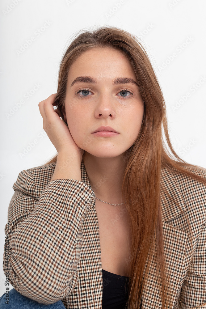 portrait of young caucasian attractive woman with long brown hair in black top and suit jacket on white background. skinny pretty lady posing at studio portrait of young caucasian attractive woman with long brown hair in black top and suit jacket on white background. skinny pretty lady posing at studio