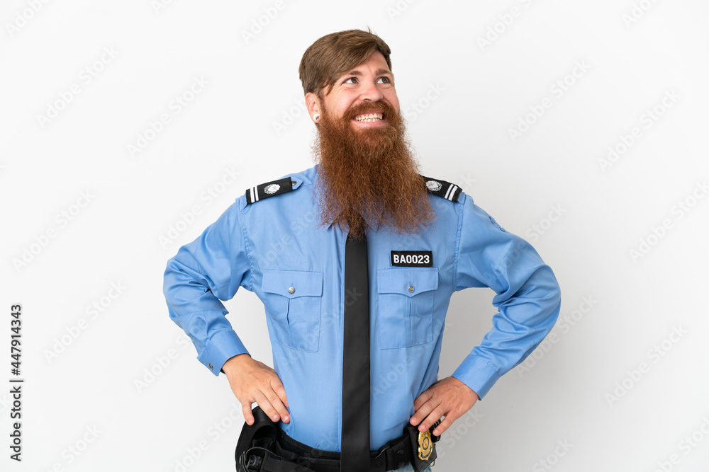 Redhead police man isolated on white background posing with arms at hip and smiling Redhead police man isolated on white background posing with arms at hip and smiling