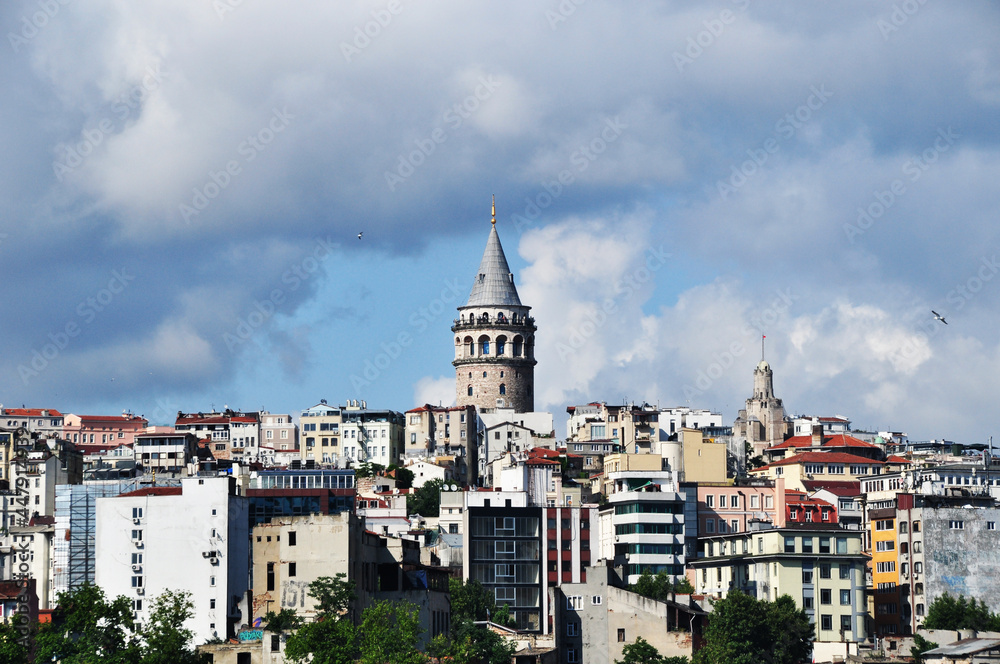 A close-up of the Galata Tower against the backdrop of residential buildings. Cityscape of Istanbul. 07 July 2021, Istanbul, Turkey.
