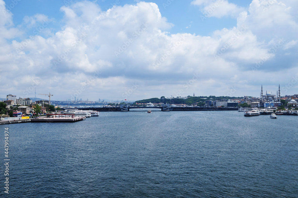 Panorama of the Galata Bridge from the side of the Golden Horn Bay. Cloudy day in the city.