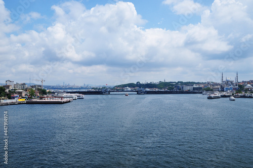 Panorama of the Galata Bridge from the side of the Golden Horn Bay. Cloudy day in the city.