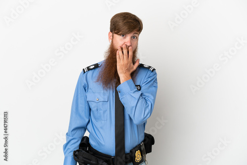 Redhead police man isolated on white background surprised and shocked while looking right