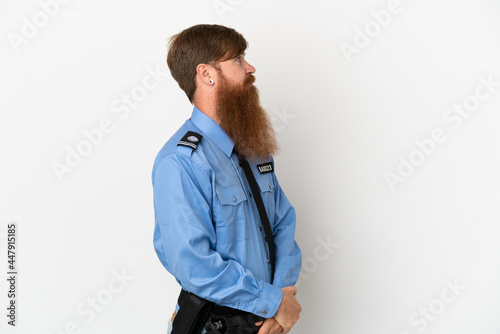 Redhead police man isolated on white background in lateral position